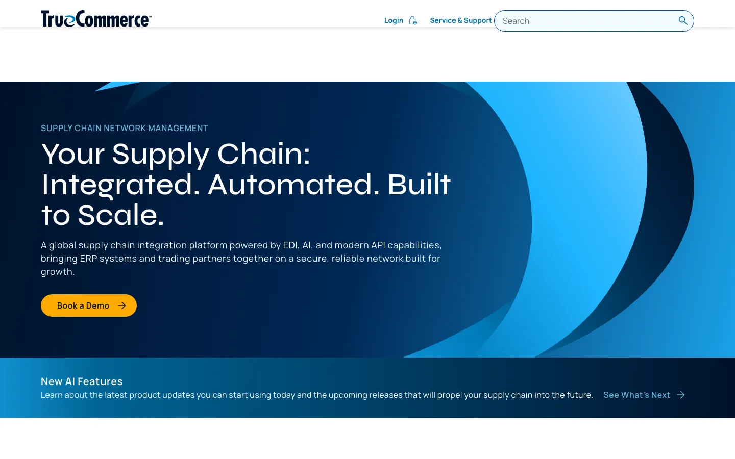 TrueCommerce’s homepage: a navy-to-blue band with large swoosh shapes, “Your Supply Chain: Integrated. Automated. Built to Scale.” and an amber Book a Demo button.